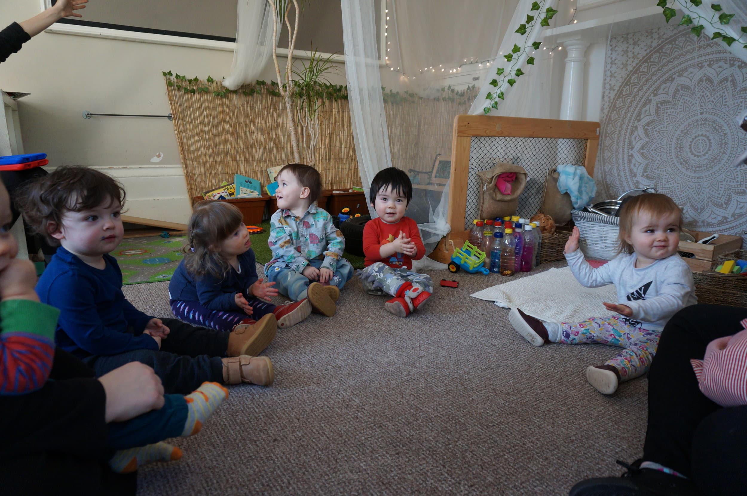 Children sitting together at circle time at Macclesfield Day Nursery